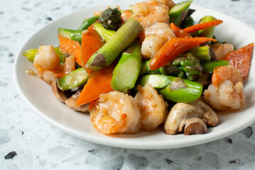 A view of a plate of shrimp and asparagus.