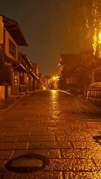 Traditional Japanese Stone Street in Rainy Night with Warm Lights