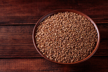 Uncooked Buckwheat Grains on Wooden Boards, Copy Space