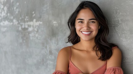 Fototapeta premium Young Latin woman with pleasant smile and crossed arms.