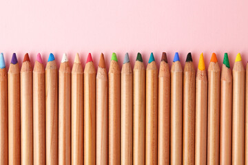 Equality concept. Different colorful pencils on pink background, top view