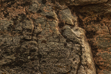 Dark red orange brown stone with cracks Closeup of uneven mountain surface
