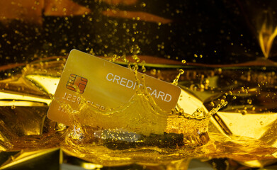 Plastic credit card create in liquid gold with trust. Golden credit card mining from gold and casting into name card shape for credit trust new money, king crown water liquid splash