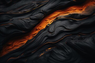 Obraz premium an abstract black and orange lava flow on a black background
