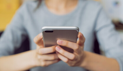Woman holding a smartphone and using social media on internet.