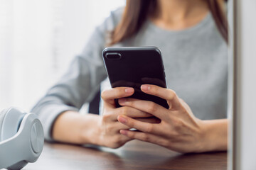 Woman holding a smartphone and using social media on internet.