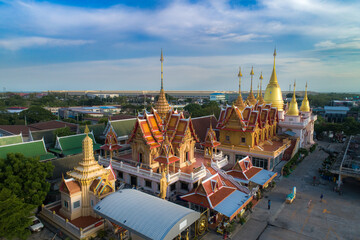 Panoramic view of thai temple with historic architecture, river, and skyline under a clear sky