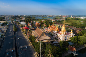 Panoramic view of thai temple with historic architecture, river, and skyline under a clear sky