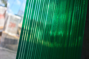 The clear glass sheets are meticulously stacked, creating a modern and elegant look