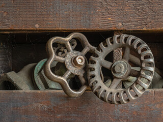 Vintage faucet handles  in an old wood rack.