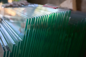 The clear glass sheets are meticulously stacked, creating a modern and elegant look