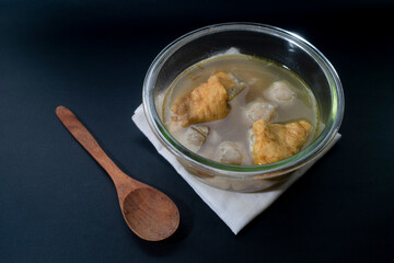 Indonesian street food. meatballs and tofu soup