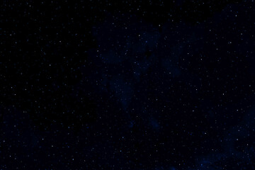 Stars in space. Dark blue galaxy space background. Glowing stars in the night. Starry night sky. New Year, Christmas and Celebration concept.	