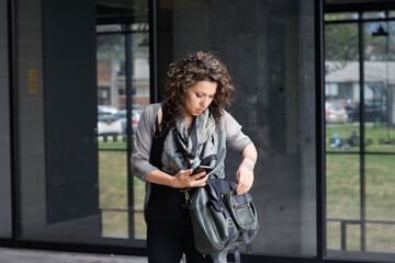 Professional Businesswoman with cell phone. Office woman. Exterior. Latina