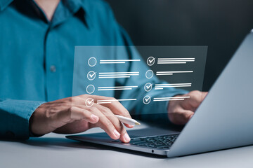 Businessman with online questionnaire with checkboxes on online laptop computer, online exam,...