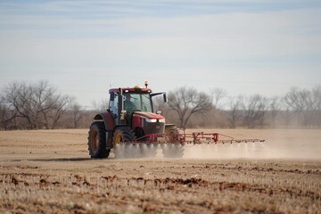 Fototapeta premium Red Tractor Spraying in a Field