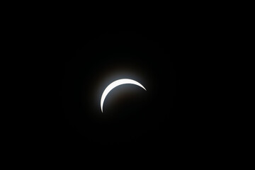 Total eclipse waxing as moon begins to cover the sun