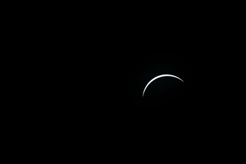 Total eclipse waxing as moon begins to cover the sun