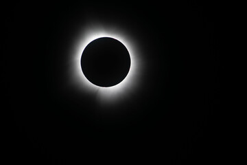 Light shining from sun around the moon creating a halo effect during the total eclipse