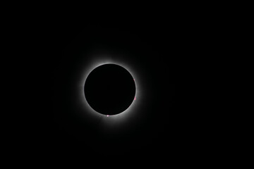Corona surrounding the total eclipse with sun spots around the moon