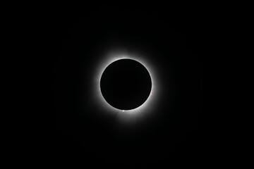Corona surrounding the total eclipse with sun spots around the moon