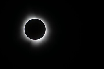 Light shining from sun around the moon creating a halo effect during the total eclipse