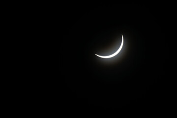 Total eclipse waning as moon begins to uncover the sun