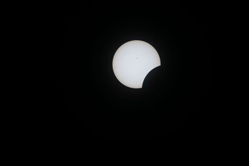 Total eclipse waxing as moon begins to cover the sun