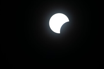 Total eclipse waxing as moon begins to cover the sun