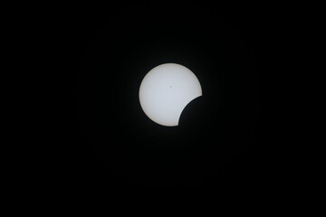 Total eclipse waxing as moon begins to cover the sun