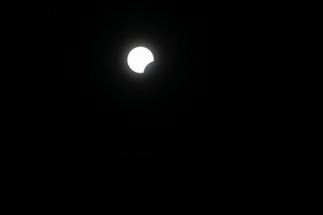 Total eclipse waxing as moon begins to cover the sun