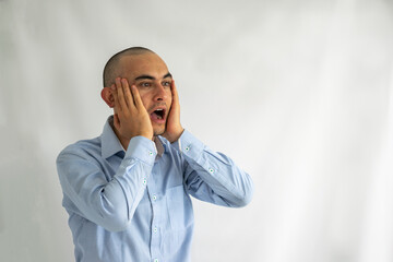 Surprised and shocked businessman with his hands on his face