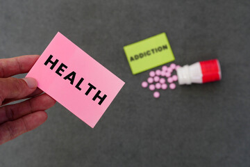 Health Or Addiction. Man chooses paper that says Health. Addiction and drug paper background
