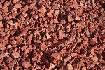 Background of red crushed bricks. Close-up of crushed brick, top view, copy space.