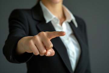 Fototapeta premium Front-facing, a businesswoman points to an empty area with his finger