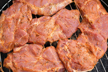 rohe Steaks auf einem Holzkohlegrill