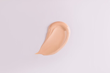 Fototapeta premium A sample, a stroke of foundation powder in a natural tone. cosmetic swatch. Mockup for the design of the cosmetic texture of the product