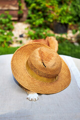 funny view of a ginger cat sitting on a straw hat