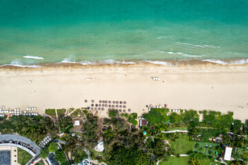 Naklejka premium perspective coastline around blue sea under sunny blue cloudy sky. Yalong Bay in Sanya Hainan China. wide angle.