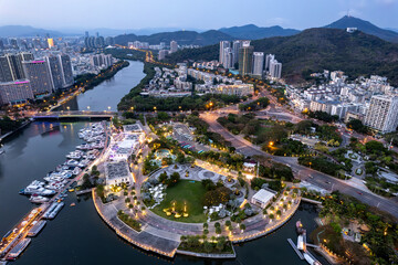 new residential quarter with typical skyscraper buildings among greenery in Santa. Tourism development of Sanya, Hainan island, China top view from above