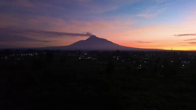 Aerial footage of the beauty of Mount Merapi before sunrise. The beauty of the view of Mount Merapi which begins to appear when the sun rises against the backdrop of a bluish gold sky