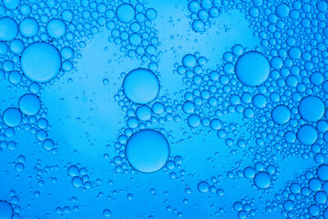 Abstract background of water drops blue bubbles of oil in liquid