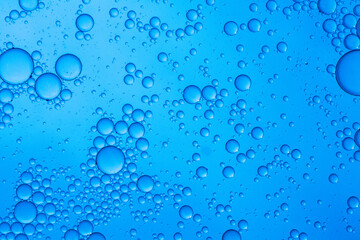 Abstract background of water drops blue bubbles of oil in liquid
