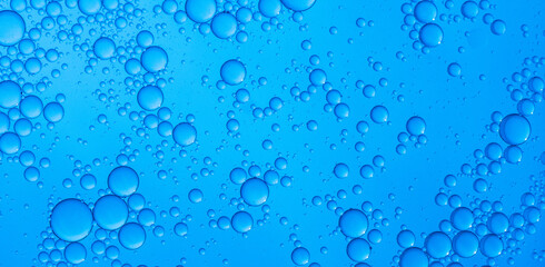 Abstract background of water drops blue bubbles of oil in liquid