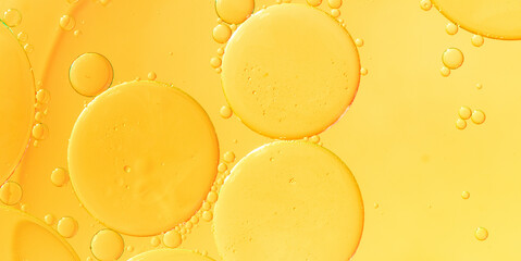 Abstract background of yellow bubbles of oil in liquid
