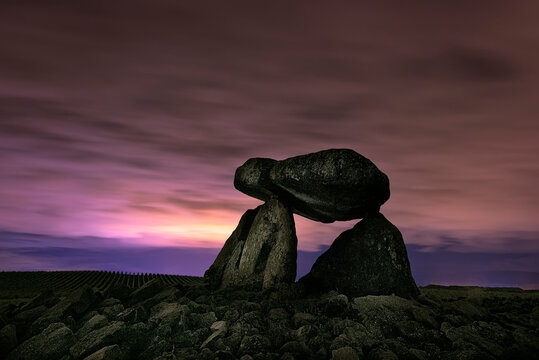 Dolmen Chabola de la Hechicera, Elvillar, Alava, with a night sky with clouds