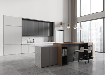 Stylish kitchen interior with eating and cooking space, kitchenware and window