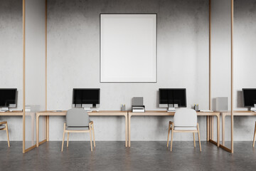 Stylish coworking interior with pc desktops on tables. Mockup frame