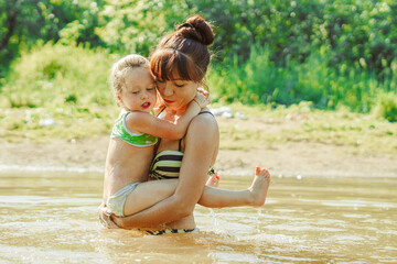 mom and child swim in the river