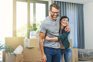 Happy, moving and couple in new home with boxes for immigration together in Canada with marriage....